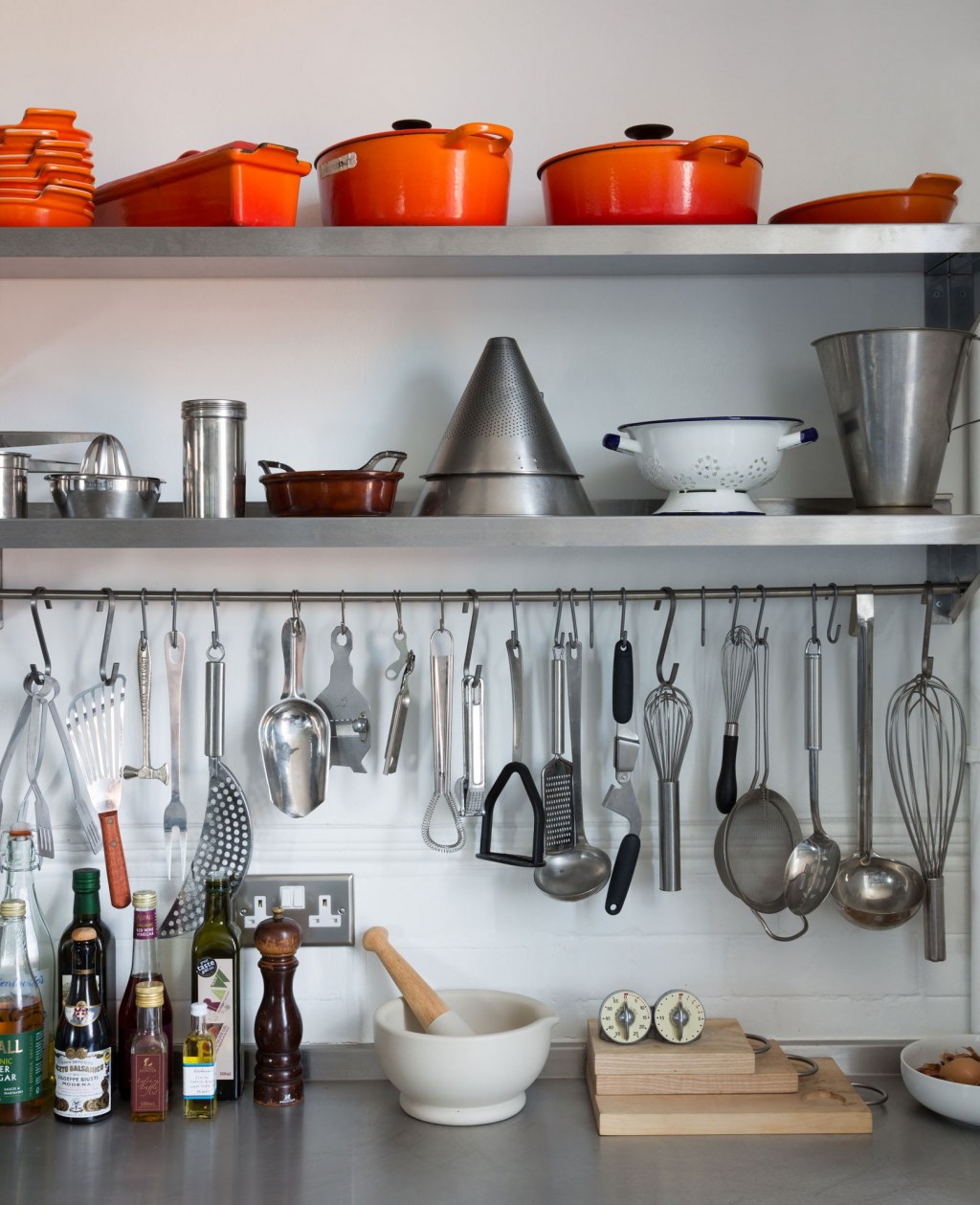 Old School House, East London / Shelving detail in kitchen with storage and cooking equipment