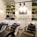 George Northwood's Hair Salon, Fitzrovia / Ground floor backwash with spa area and shelving with plants and herbs