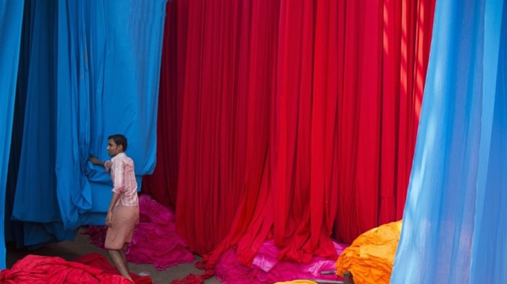 South Asian Gallery / Touchstone image of newly dyed fabric drying on bamboo frames