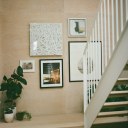 The Coach House / AS warm timber stairwell provides a wall for art and a respite from the minimalist concrete floor